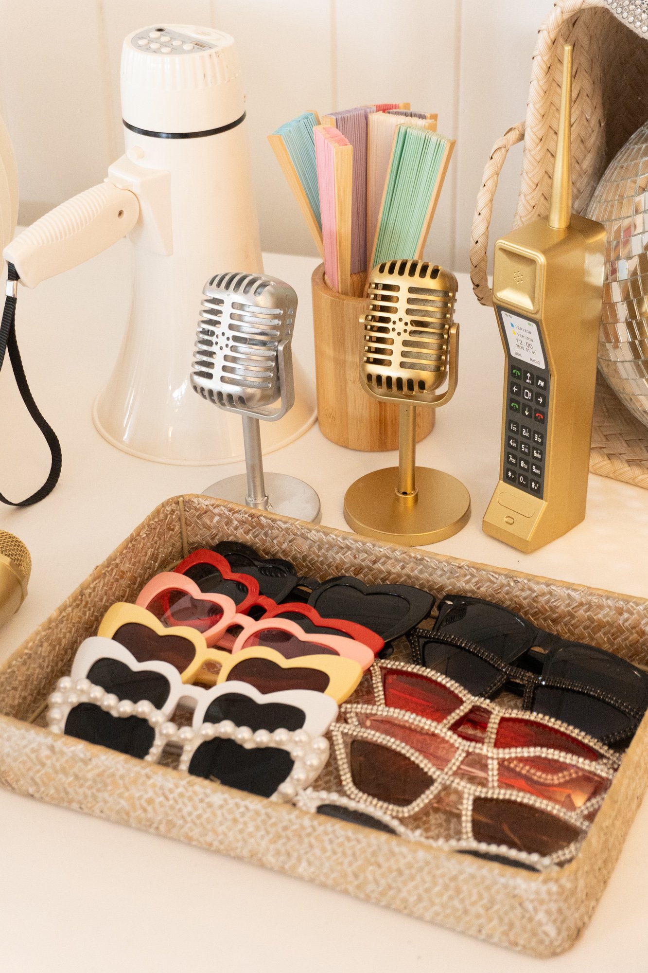 Curated wedding photo booth props including retro accessories and modern signage.