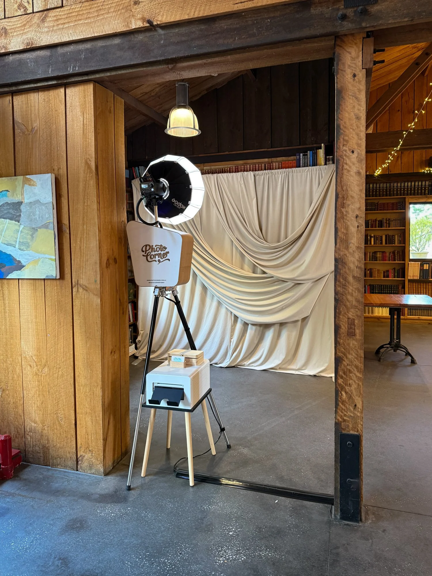 Photo Corner photo booth setup with the Golden Hour Velvet Drape backdrop at Bendooley Estate Book Barn in Berrima.