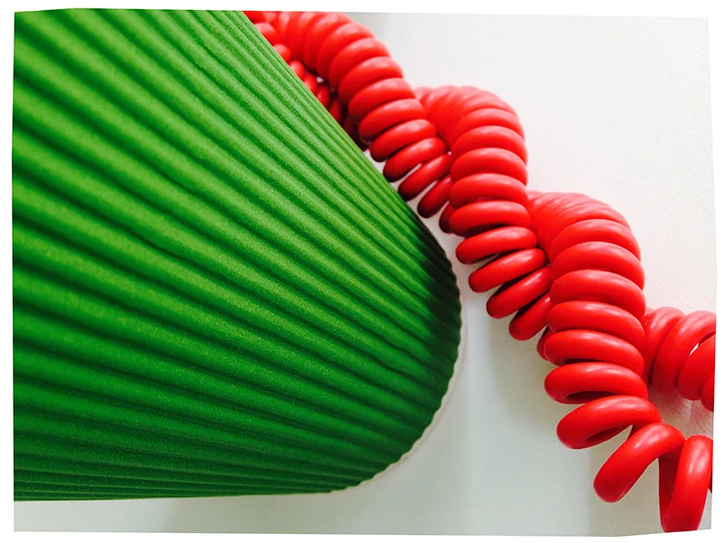 The green paper cup and my phone cord.