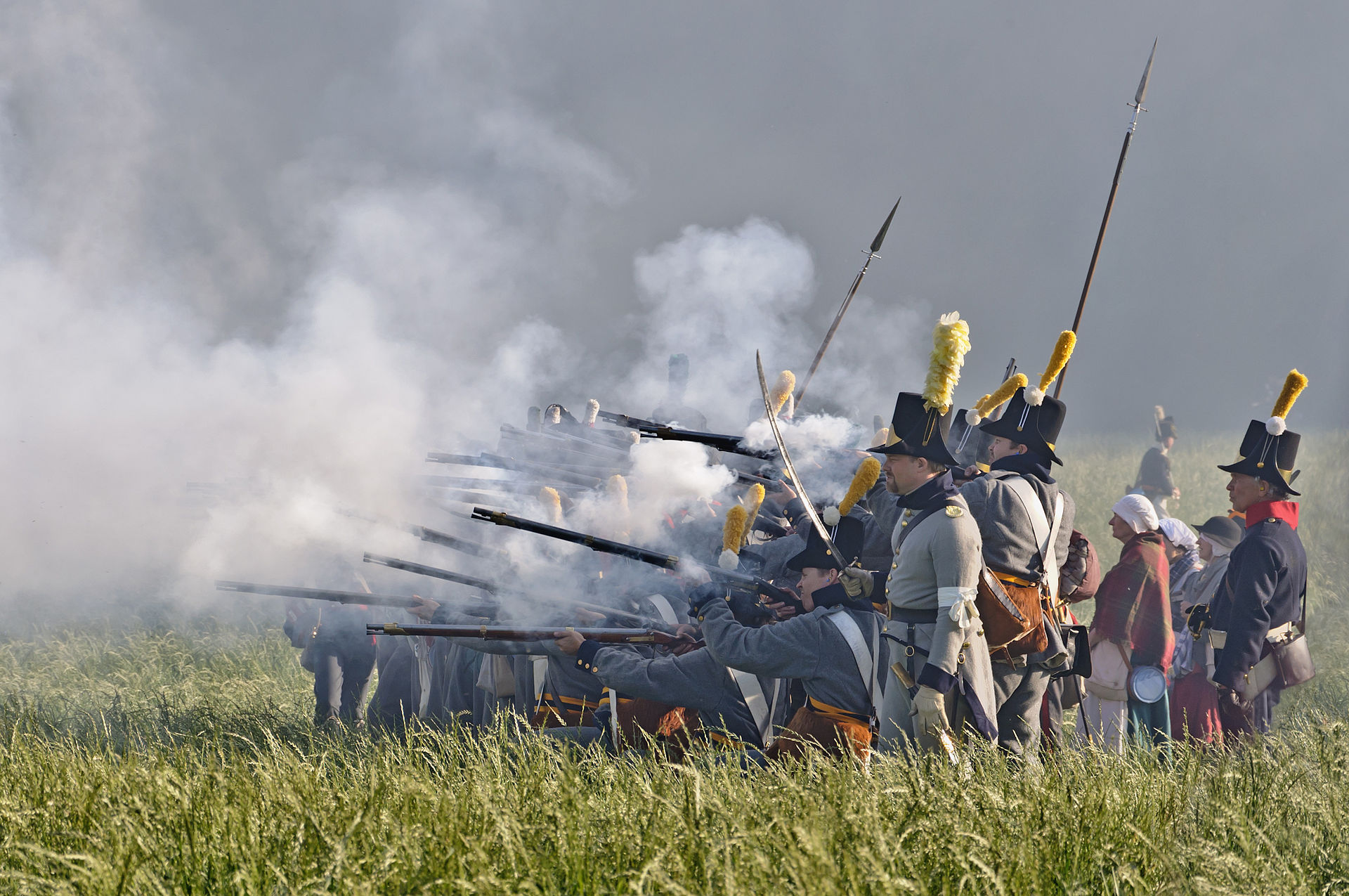 Soldiers in front of the wood of Hougoumont during the reenactment of the battle of Waterloo (1815), June 2011, Waterloo, Belgium, via Wikipedia .