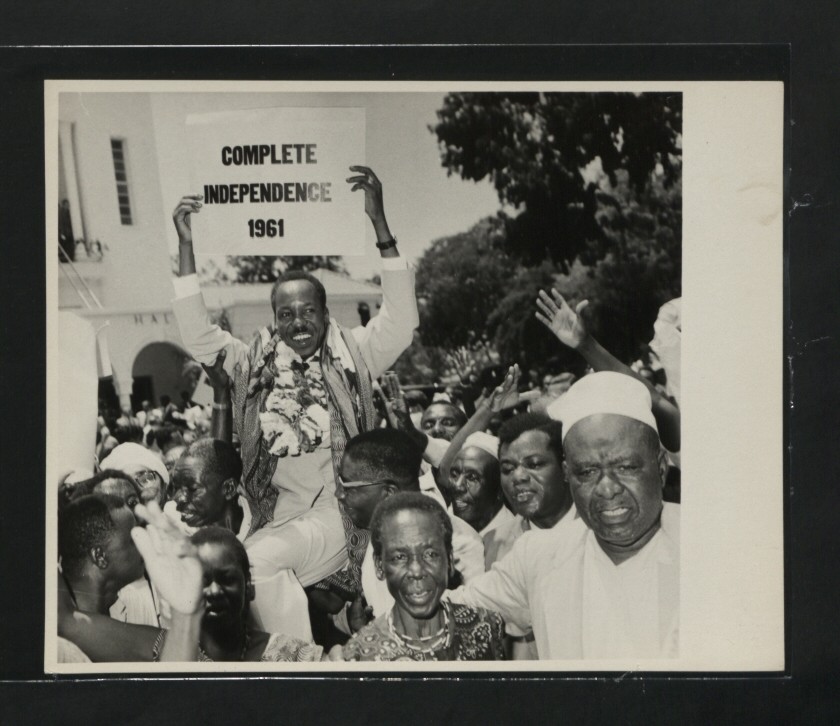  Julius Nyerere holding a sign demanding complete independence from the British Empire in 1961, Photo from the National Archive via Wikipedia .