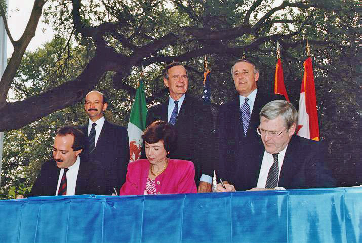 Signing of the North American Free Trade Agreement in 1992, via Wikipedia .