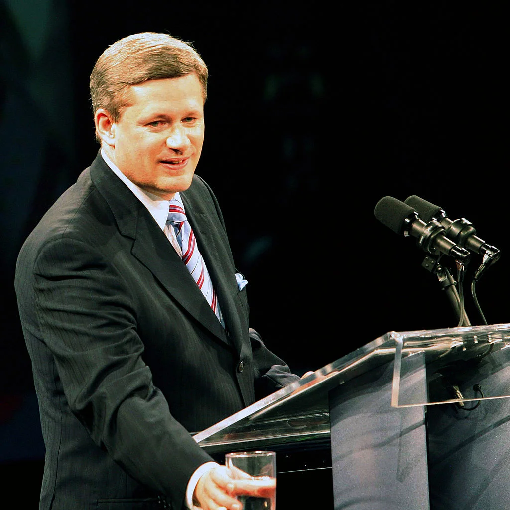 Newly minted Prime Minister Stephen Harper in 2006 addressing party faithful, via Wikipedia .