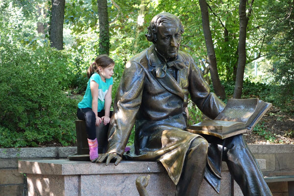 Reading alongside the Hans Christian Andersen statue at New York's Central Park.