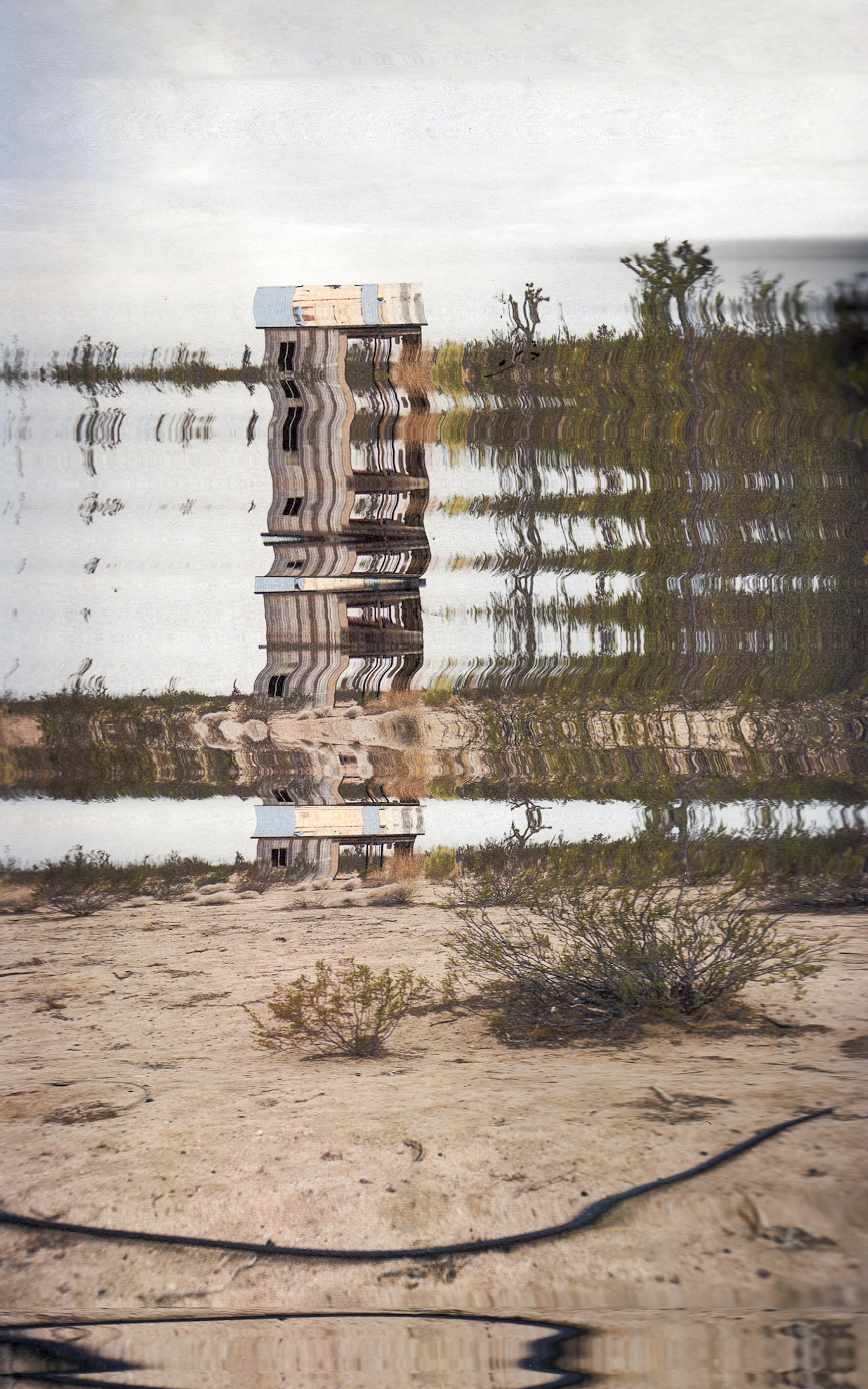 Luttrell’s current body of work entitled No Man’s Land brings forth a nuanced portrayal of CaliforniaCity, California. Located on 80,000 acres of Mojave Desert land, real estate developer Nat Mendelsohn purchased the site in the 1950’s with the intention of creating the next great city in California, rivaling Los Angeles in its size. Mendelsohn’s vision never became reality, however, and as of 2010, 14,120 people called California City home living amongst unbuilt roads and empty cul-de-sacs that were intended to become a place where California’s middle class could flourish. No Man’s Land includes a series of digital images created through a process where Luttrell printed photographs that she took and re-scanned them, manipulating the photographs as the scanner processed the image. The result is a set of arresting works that take representational images and re-imagine them as abstracted landscapes that recall the bent light rays produced by mirages. By introducing this element, Luttrell keenly draws a connection between the false visions evoked by a mirage and the failed utopian project that California City has become. The word utopia has become synonymous with the idea of a “perfect society”. However, upon consideration of its definition, one realizes that the egalitarian ideals of a utopian society contradict the capitalistic power structures that dominate the globalized world. What’s to be made of the fact that California City, a failed attempt at building out a utopian enclave, sits in ruins? Do the works suggest the impossibility of escaping capitalism? Luttrell’s works could be read as a parable warning us of an impending apocalypse unless we can figure out how to embrace a more balanced, financially equal society. The desert landscape as a subject matter also recalls images of the devastating effects of Global Warming. One of the primary reasons for California City’s demise was the intense dust storms that rolled through the planned city’s unpaved streets which is evoked in the video “desert dust”. It seems more than coincidence that this reality has been mirrored in the collapse of towns across Texas (and the World) that have literally dried up due to the devastating effects of climate change. Luttrell’s portrayal of the demise of this modern ghost town leaves us to ask ourselves – do we continue to stay the course at the risk of creating a world dotted with our own versions of California City? -David Yun, Director of Backstock Gallery