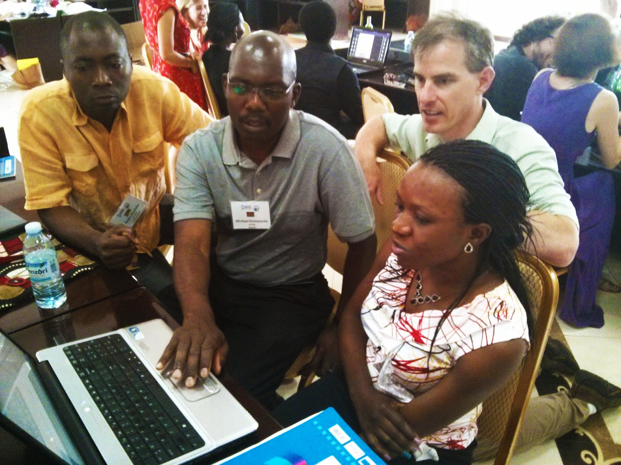 One of the developers of Bloom, John Hatton, looks on as workshop participants utilize Bloom at the Peace Corps Africa Literacy Workshop.