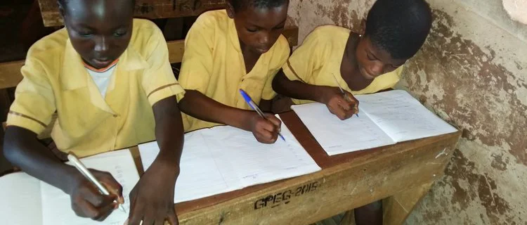 Dagomba children practicE writing in locally-purchased exercise books provided by LDP.