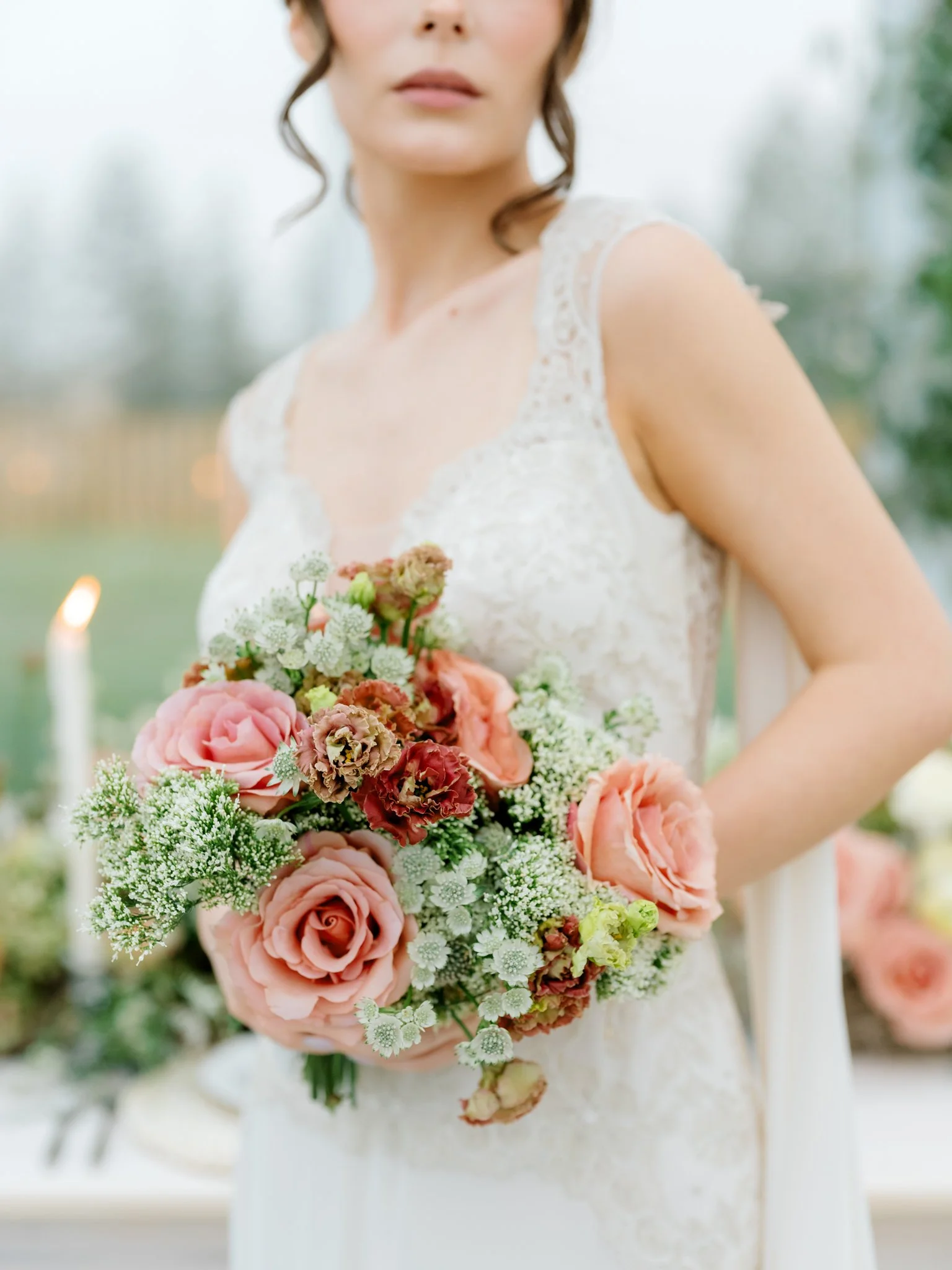 Woman in wedding dress holding a bouquet of pink and white flowers outside at Greenhouse on Harvard near Spokane, Washington