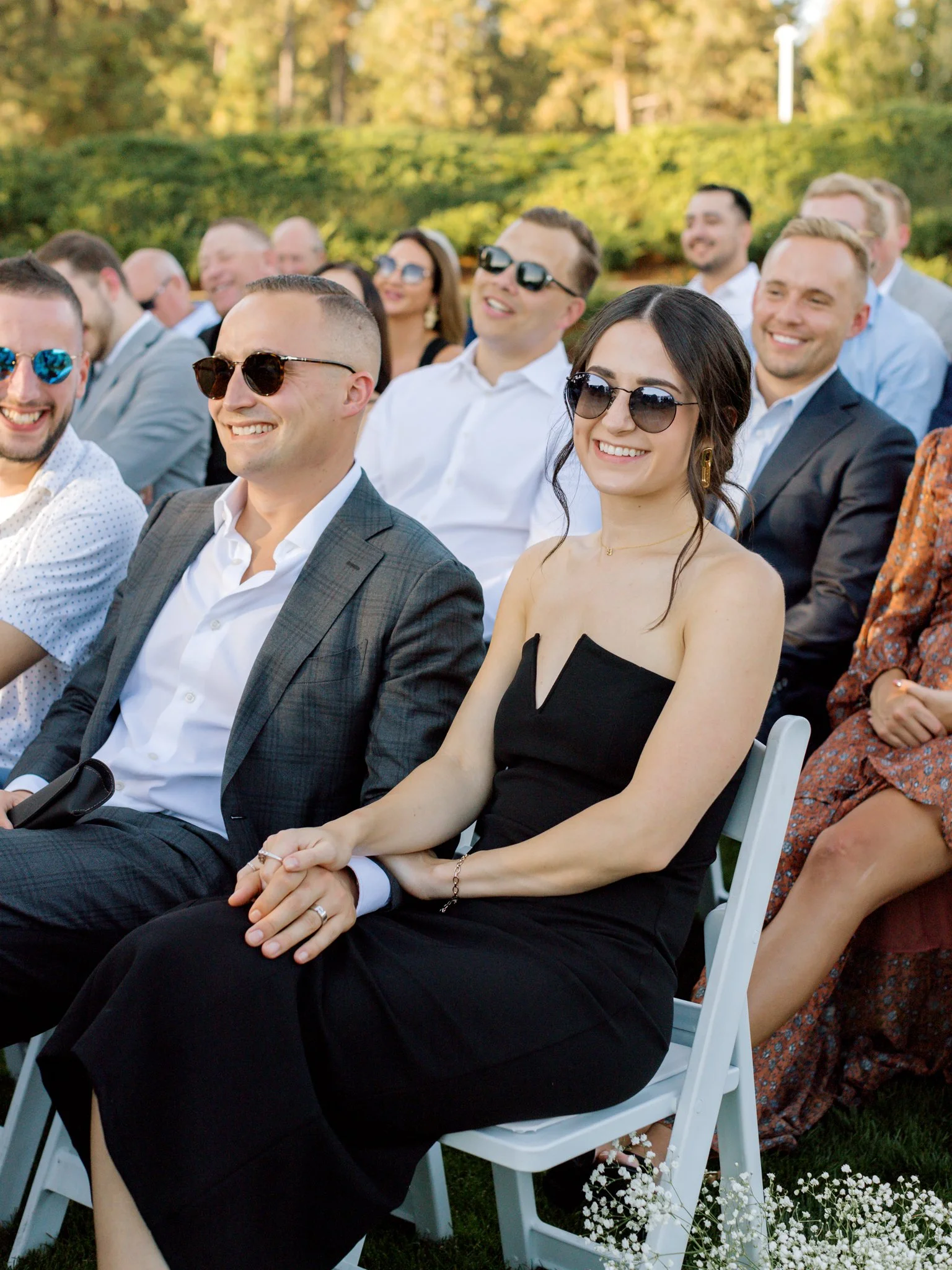 Wedding guests smiling and reacting during the ceremony at the Hagadone Event Center in Coeur d’Alene.