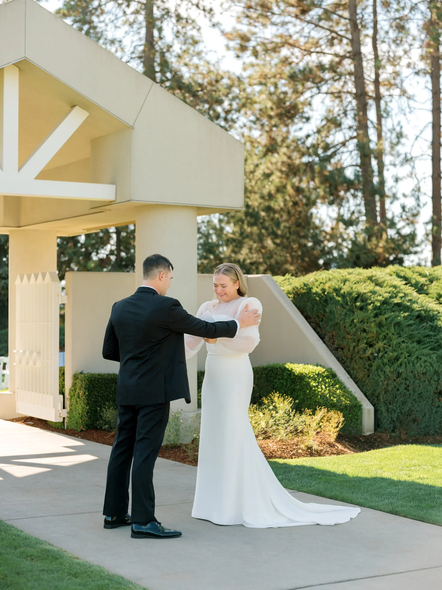 Bride and groom sharing an emotional first look beneath the pavilion at the Hagadone Event Center in Coeur d’Alene.