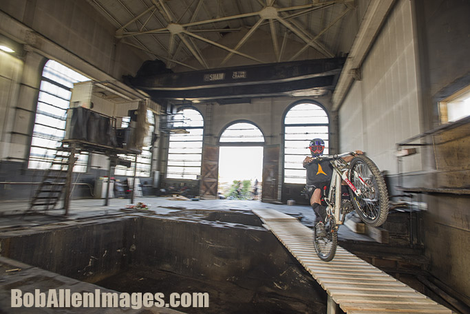  Jed Donnelly rides a wheelie across a ladder bridge in The Con mine at the Evel Urban Downhill practice. 