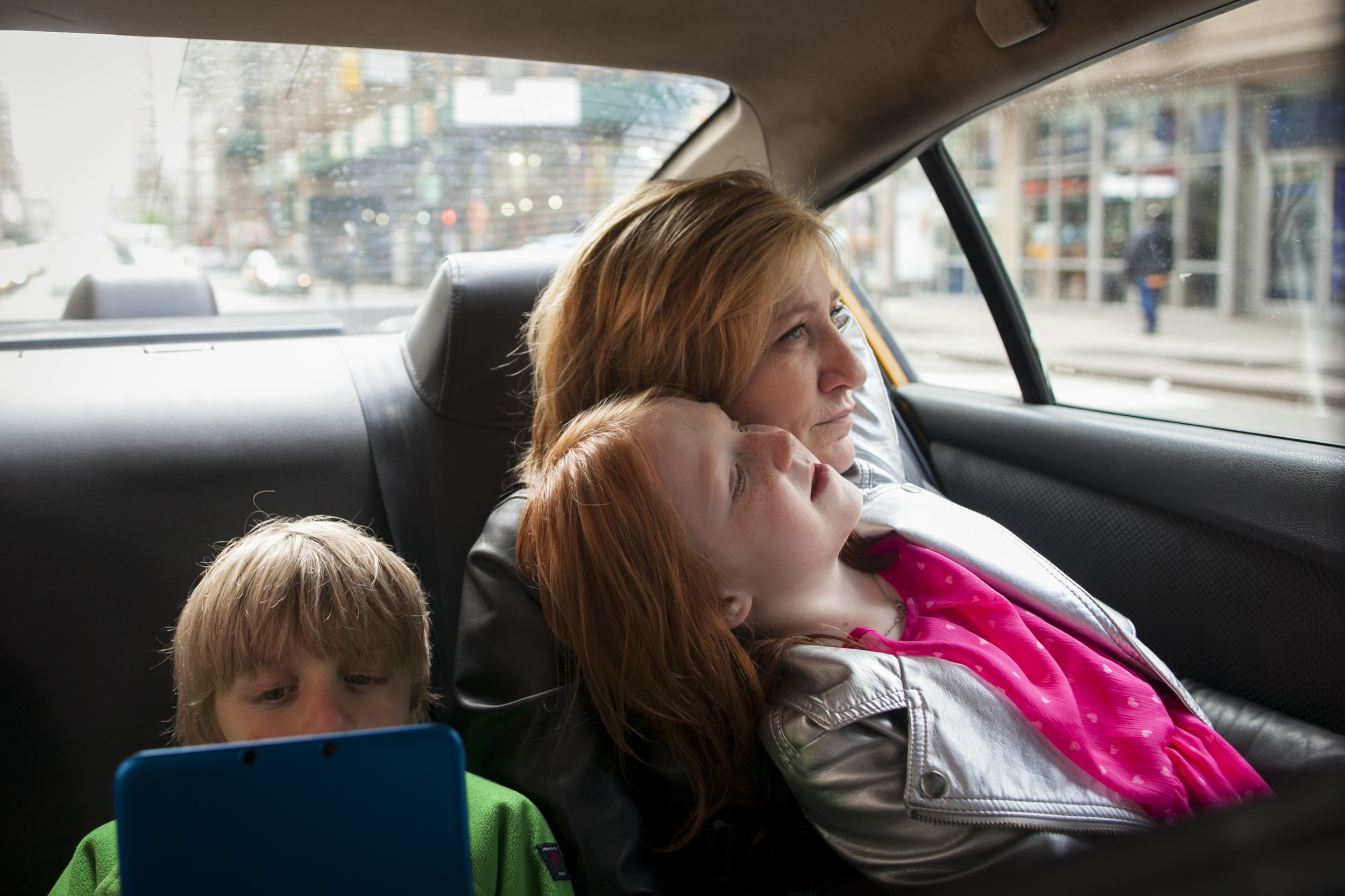 Actor Edie Falco in a taxi with her children Anderson and Macy.