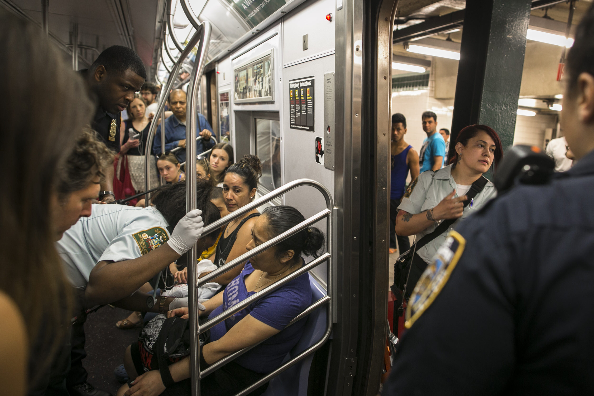  EMTs attend to a sick passenger. Brooklyn, NY  