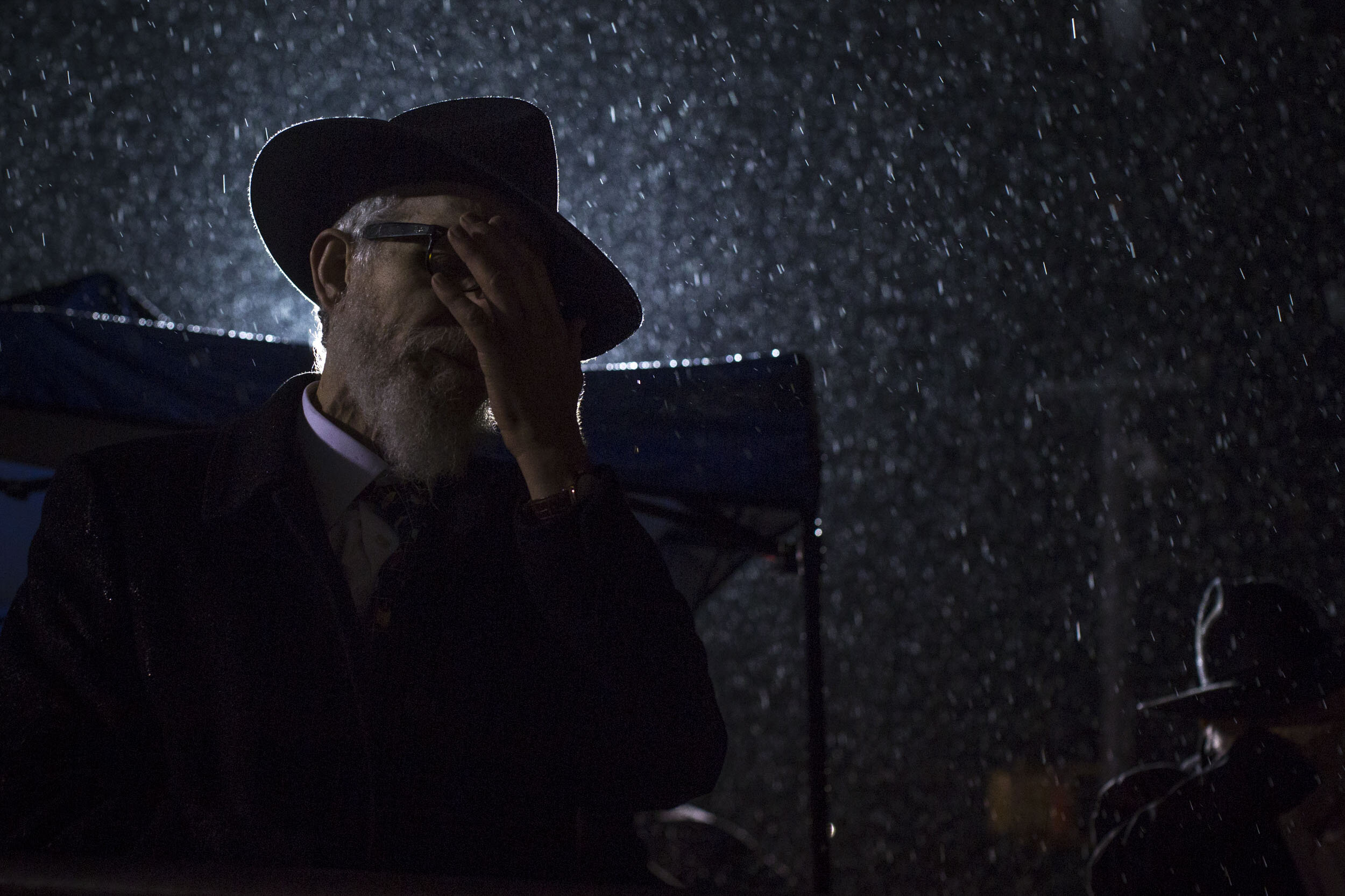  A rabbi prays following a machete attack at a Rockland County synagogue. Brooklyn, NY 