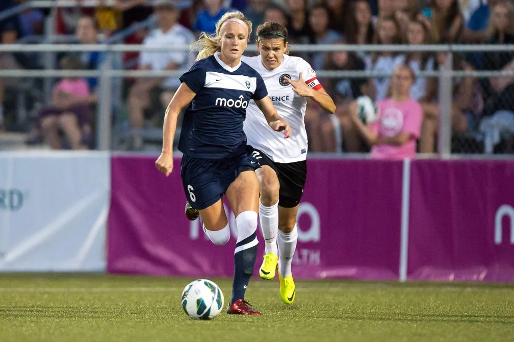 Kaylyn on the attack vs Portland with Christine Sinclair of Canada Soccer chasing her.