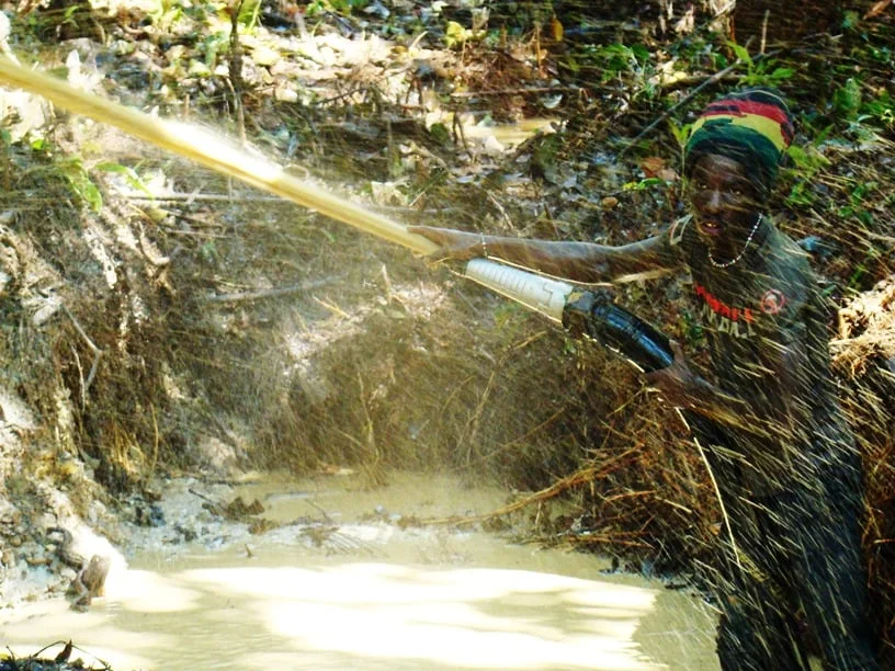 An illegal gold miner scours the forest soil (photo by William Laurance)