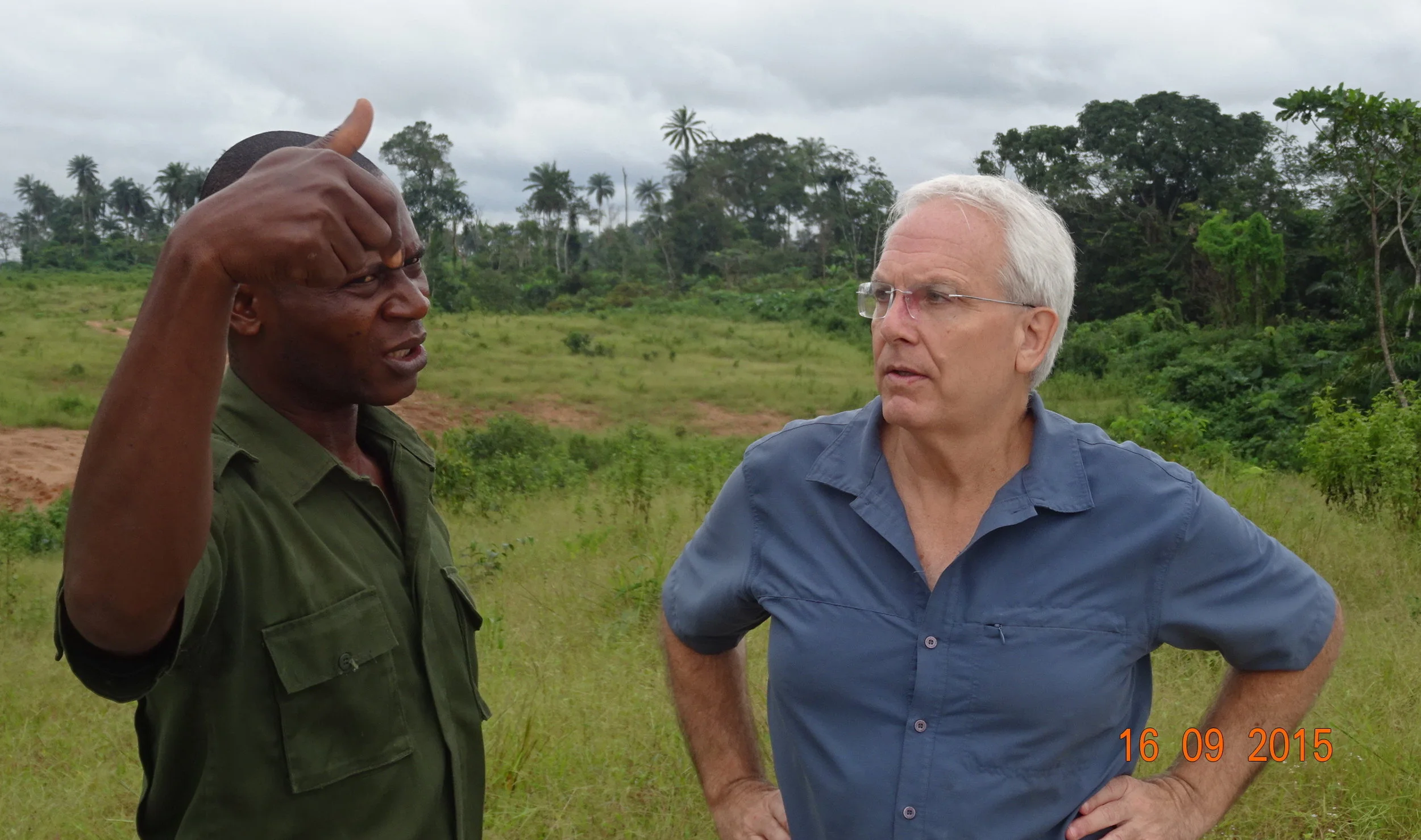 ALERT director Bill Laurance inspects the road clearing near Cross River National Park, guided by a park guard (photo by Mahmoud Mahmoud).