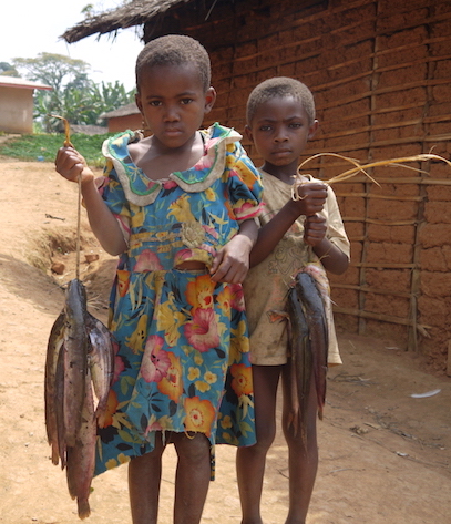 Village kids in the Congo proudly displaying their catch (photo by Bill Laurance)