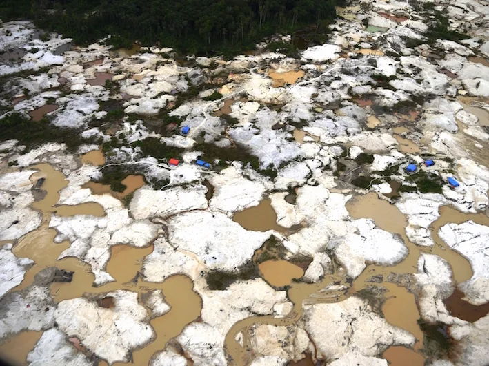 Illegal gold miners ravage a river in central Sumatra (photo by Bill Laurance)