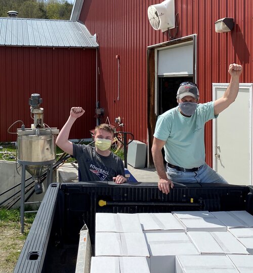 Andrew Meyer and Carter Bailey from Vermont Soy loading up Gaye’s Truck with sanitizer to distribute to grantees and farmer’s markets.