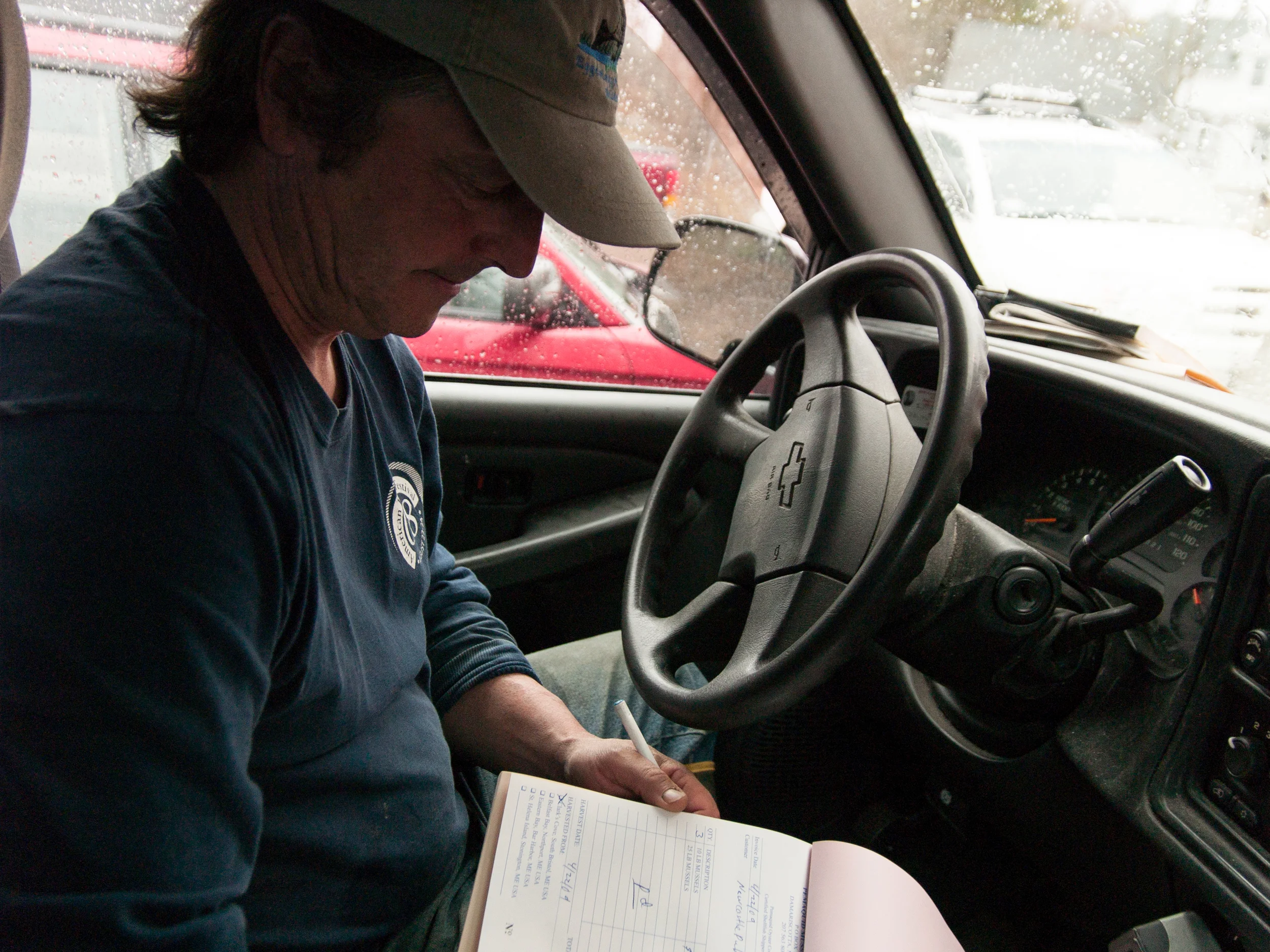 (04/22/09) Carter Newell checks his records while making mussel deliveries.