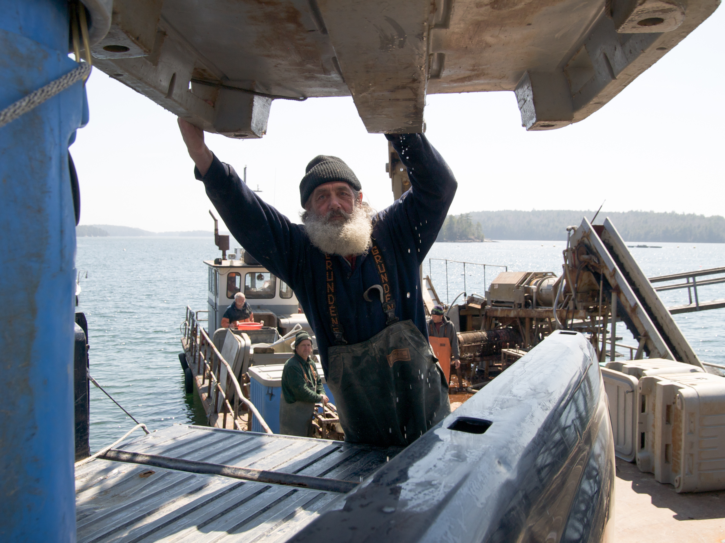  (04/25/09)&nbsp;Joe Larrabee guides one of the plastic totes filled with bags of mussels onto the back of a pickup truck. Once all the mussels are loaded onto the different trucks, the crew drive off to various restaurants and wholsalers to make the