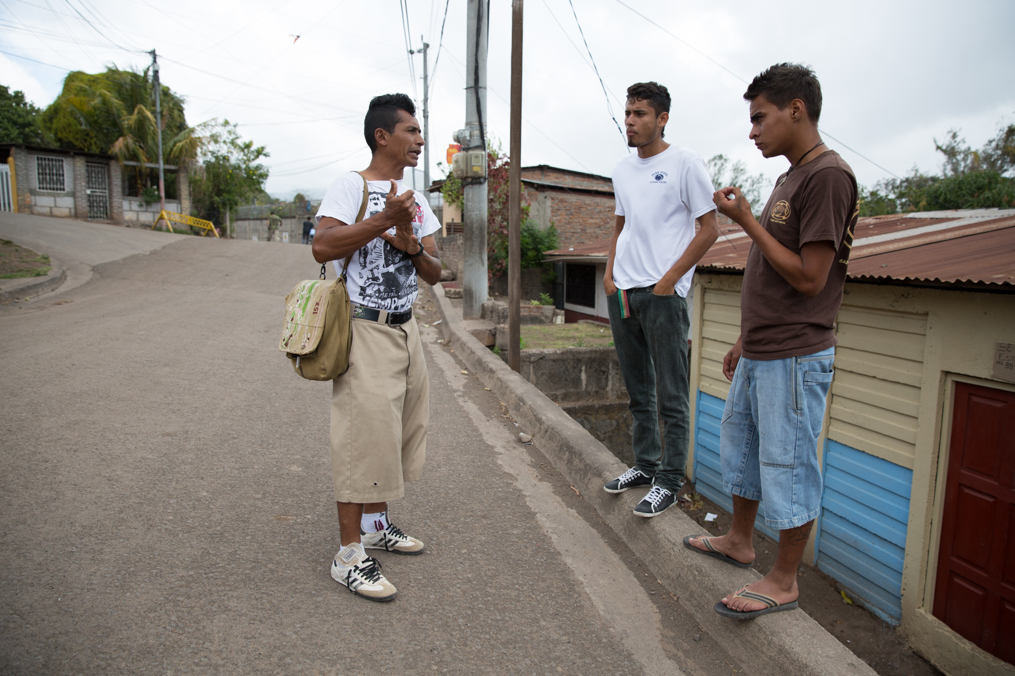  Jairo Blanchard (left) speaks with two boys in his neighborhood who are members of a gang called Mata Perros (The Dog Killers). He says this gang is one of the ones he has a lot of problems with because some of the members are involved with alcohol 