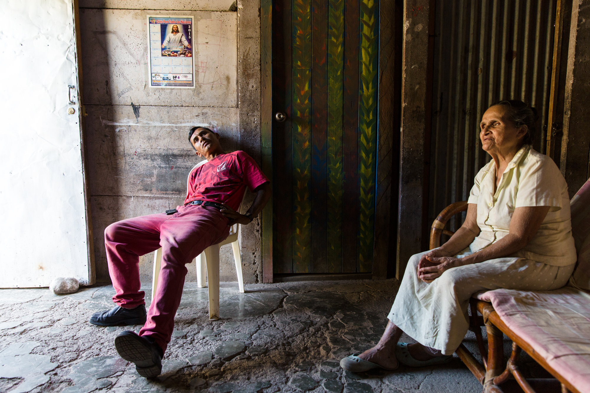  Jairo Blanchard (left) sits at home with his mother who he cares for. She is both blind and diabetic. 