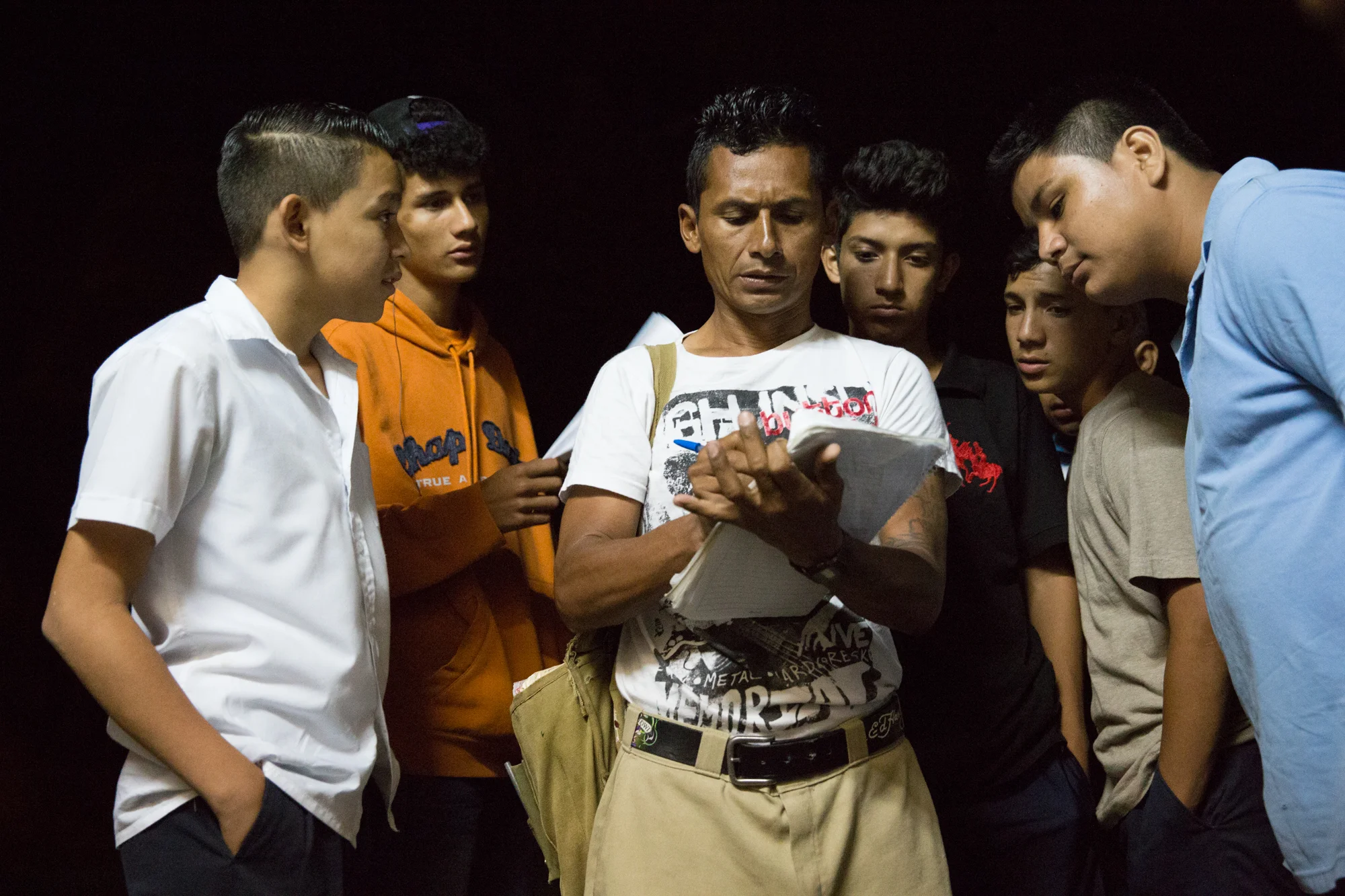 Local youth crowd around Jairo Blanchard (center) as he signs them up to join a soccer league in Matagalpa, Nicaragua.