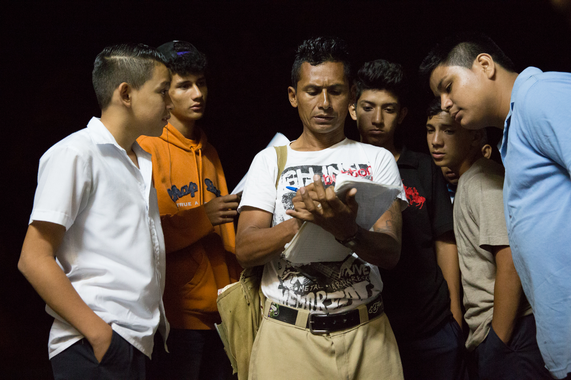  Local youth crowd around Jairo Blanchard (center) as he signs them up to join a soccer league in Matagalpa, Nicaragua. 