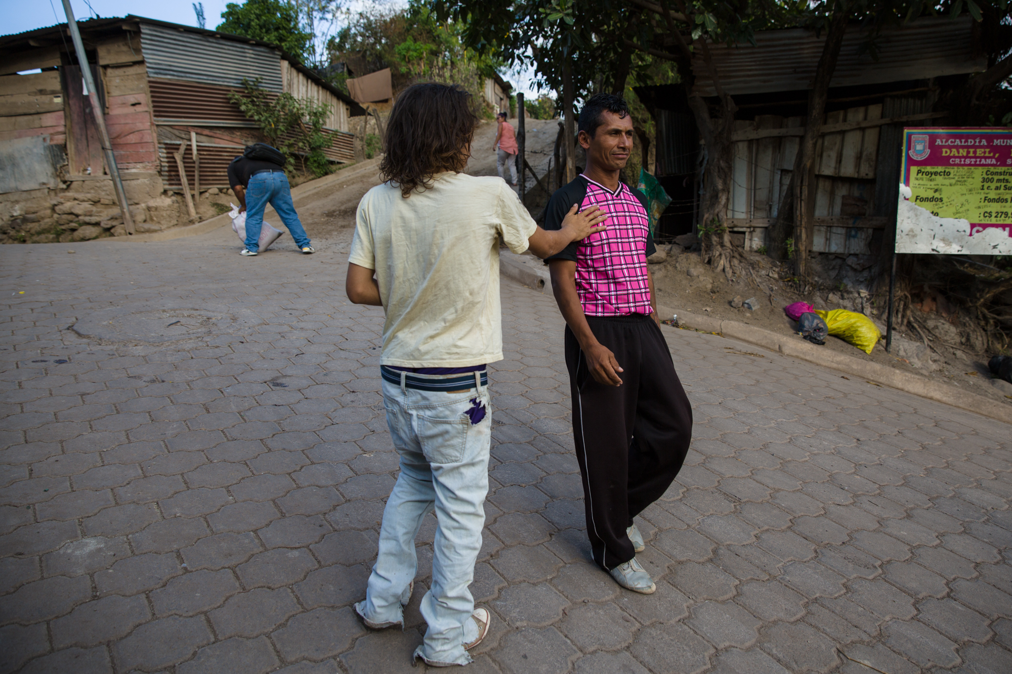  A boy holding a bottle of glue greets Jairo Blanchard on the street. Many of the street children sniff glue or sometimes even spray paint. Glue is cheap and they can often get it from shoe shops. The children aren’t necessarily homeless but may come