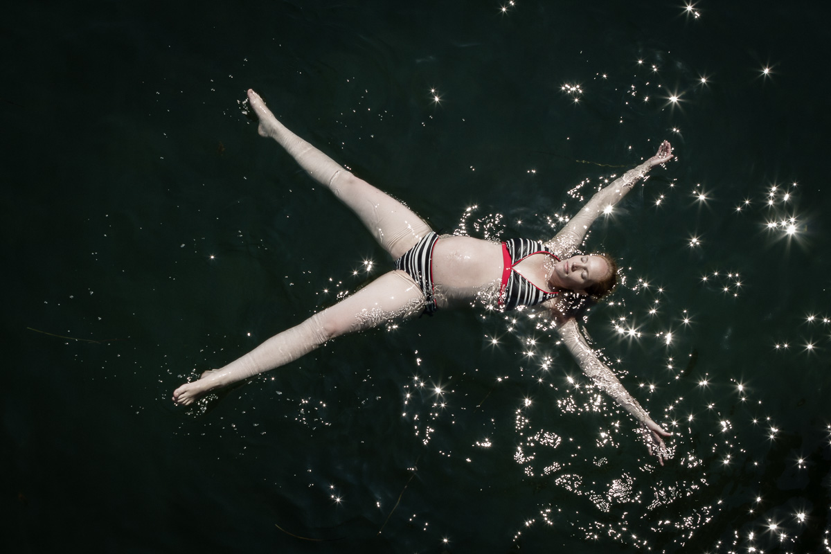 August 2014; Fort Pond Bay, Montauk NY Since getting the wonderful news of her pregnancy, Amanda fantasized of the idea of going to Fort Pond Bay to submerge herself in the calm waters and sense weightlessness. Feeling that her body is changing, movements becoming more restricted and knowing that the window for baby and mom to be together as one floating in the bay is closing, the fantasy became a strong desire. She had been wanting to do this for the past eight months, and when it happened; it was magical!