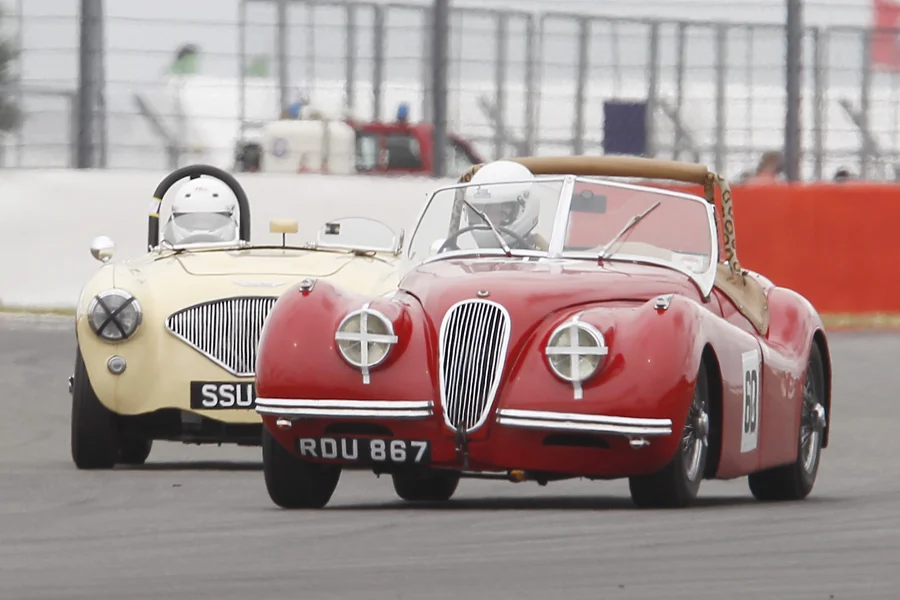 Geoff Ottley in his Jaguar XK120 has Austen Wells undivided attention! Photo - Mick Walker