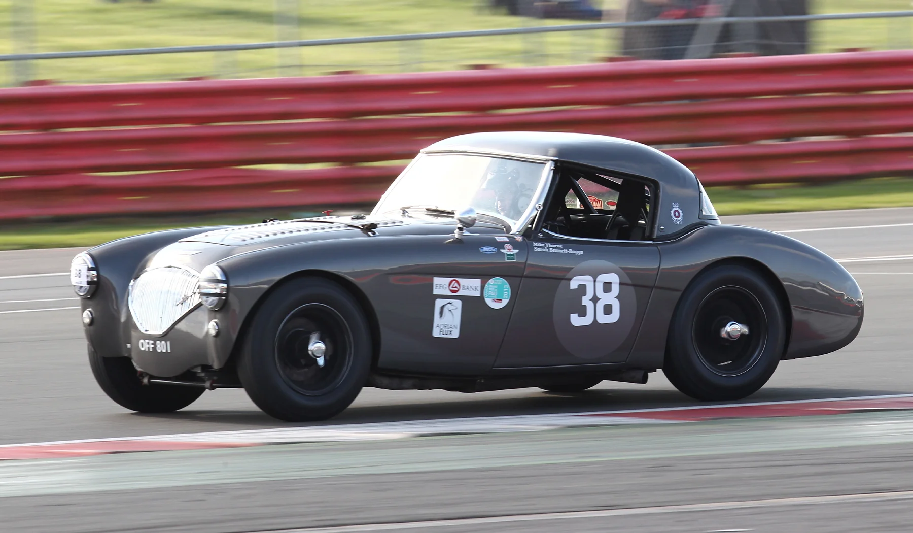 One of the heroes from last year's Castle Combe race! Mike Thorne presses on in his Austin Healey 100M Photo - Richard Styles