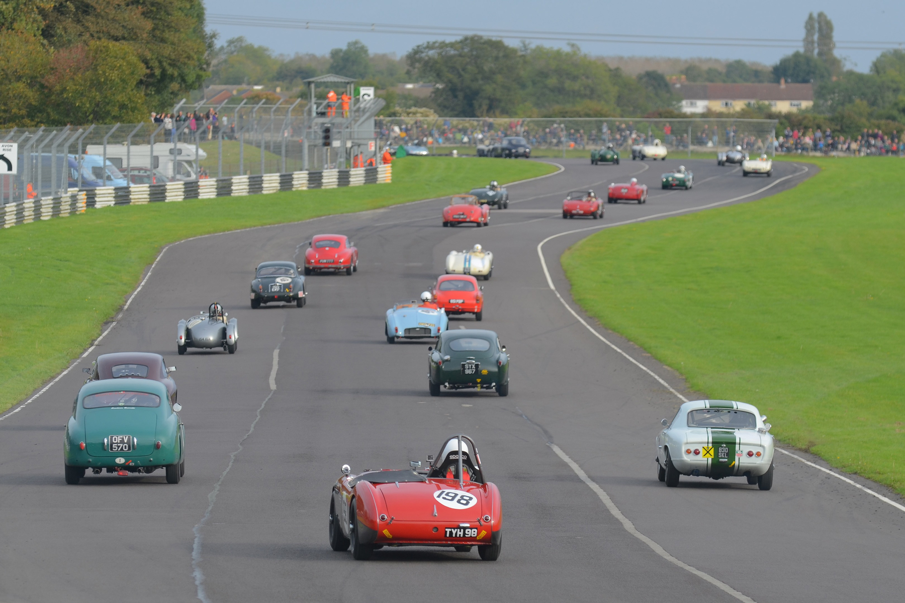The Austin Healey 100/4 of Nick Matthews (no qualifying time recorded!) is tail gunner to this big field.as they head out on the formation lap. How many marques and models can you identify? Photo - Ollie Read