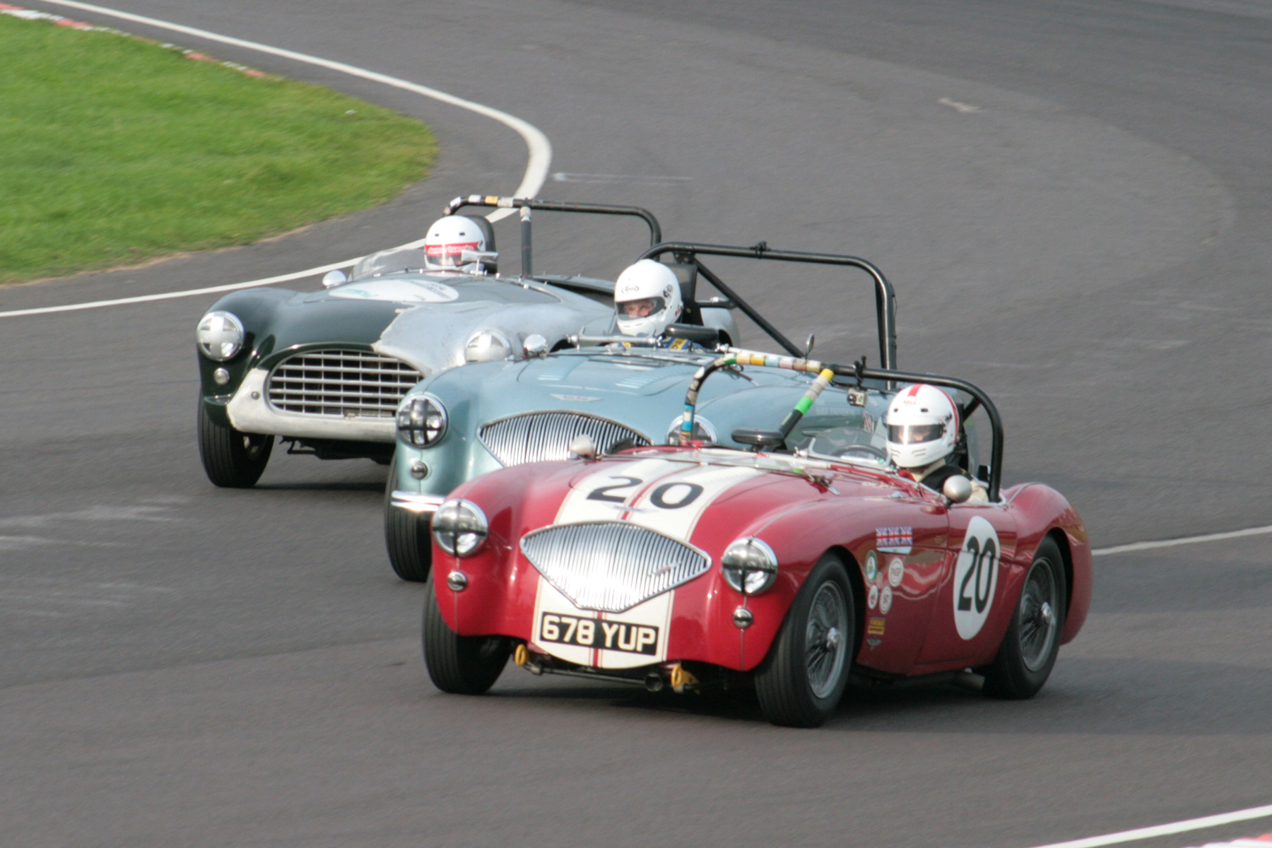 Close racing! The Jonathan Abecassis Austin Healey, the Neil Hardy/Nils-Fredrik Nyblaues Austin Healey and the Murray Shepherd AC Ace Bristol. Photo - John Turner 