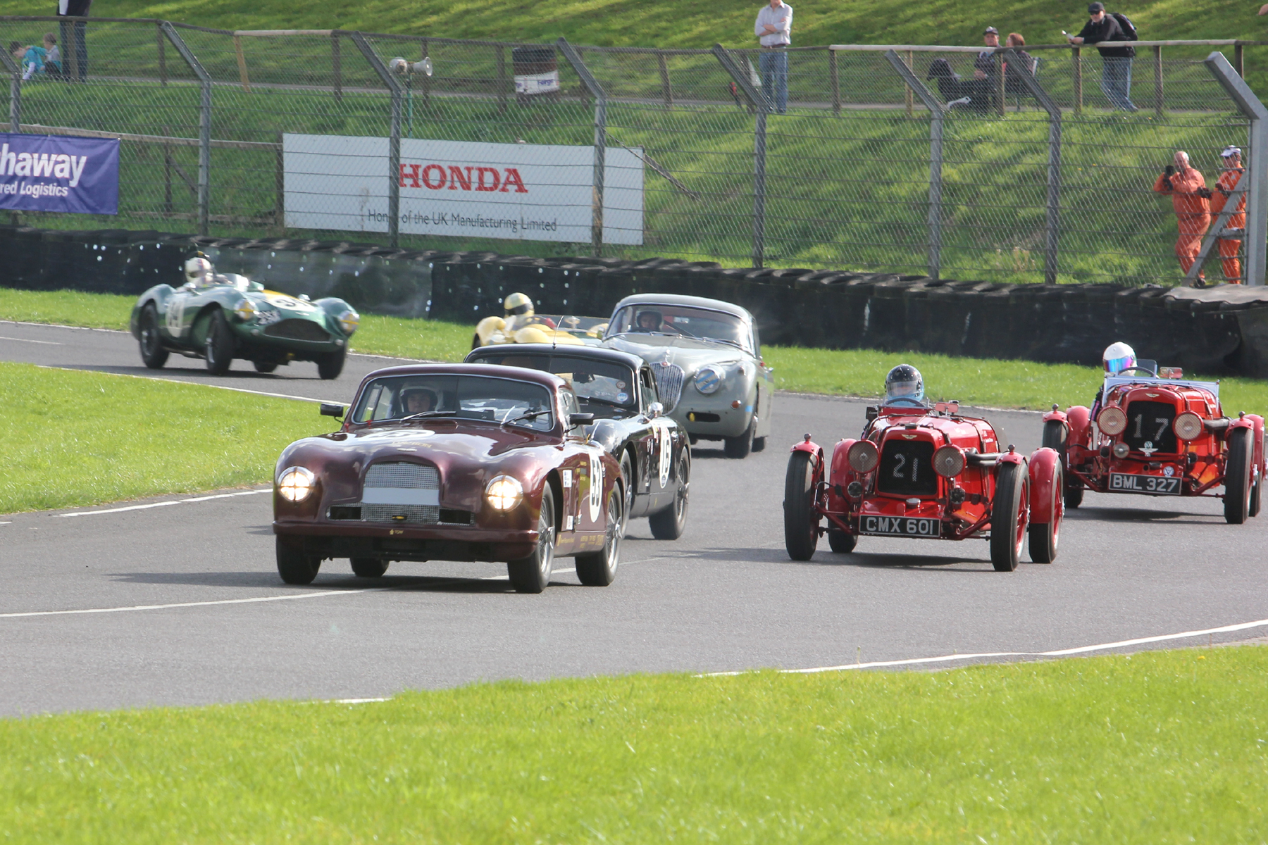 Annette Mason and Holly Mason-Franchitti stay wide as the 5 car battle for 2nd place comes steaming through Tower Corner in the order Reed, Jolly, De Havilland, McCulloch and Boultbee-Brooks. Photo - Pat Arculus.