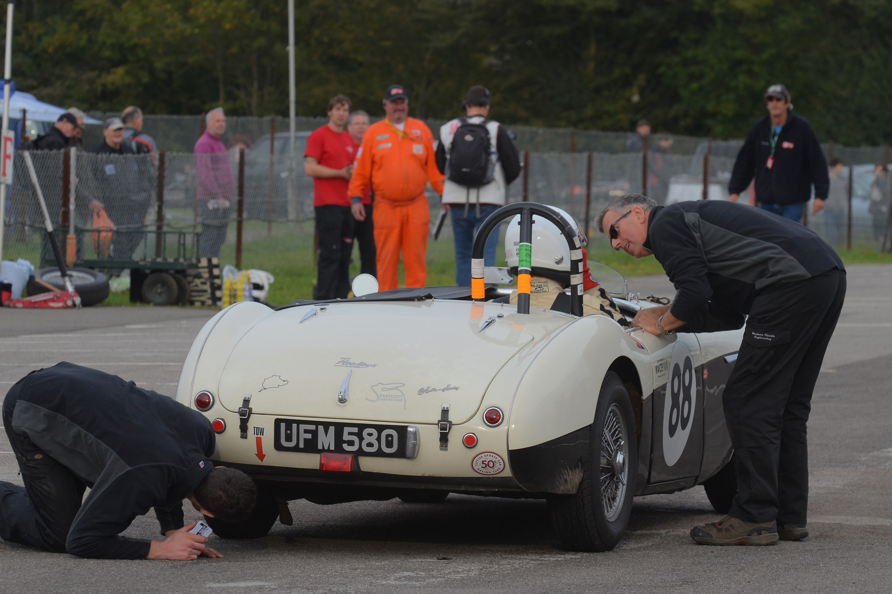 FISCAR hospitality supplier and sponsor, Paul Woolmer (Woolmer Classic restoration) ensures that all is well with Jeremy Holden in his recently acquired Austin Healey. Photo - Ollie Read