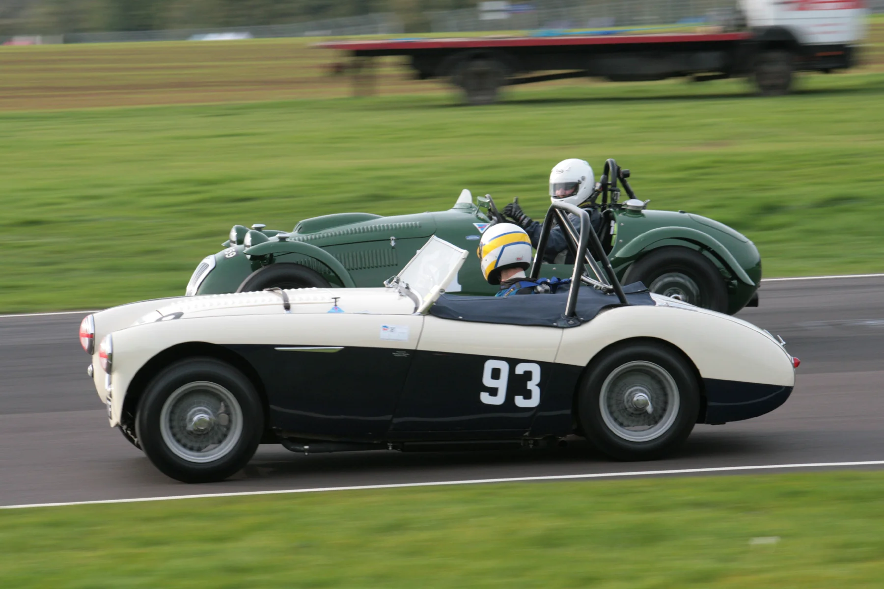 Richard Woolmer, driving Matthew Collings Austin Healey 100M, glances across at Martin Hunt, in the Frazer Nash Le Mans Replica and gets the thumbs up. They finished 14th and 12th respectively. Photo John Turner
