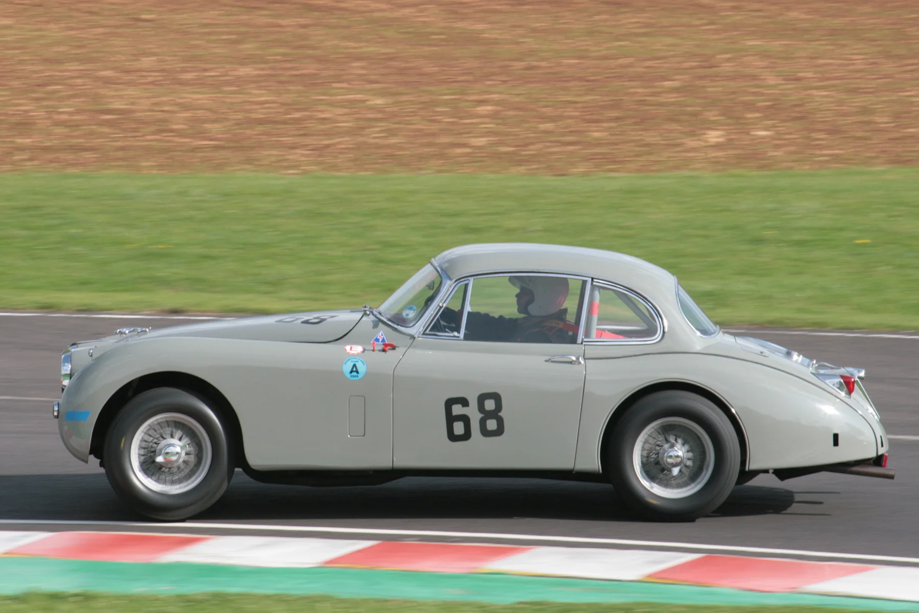 Great drive to 3rd by an under the weather Paul De Havilland and minus gear knob in the Jaguar XK150 Photo - John Turner 