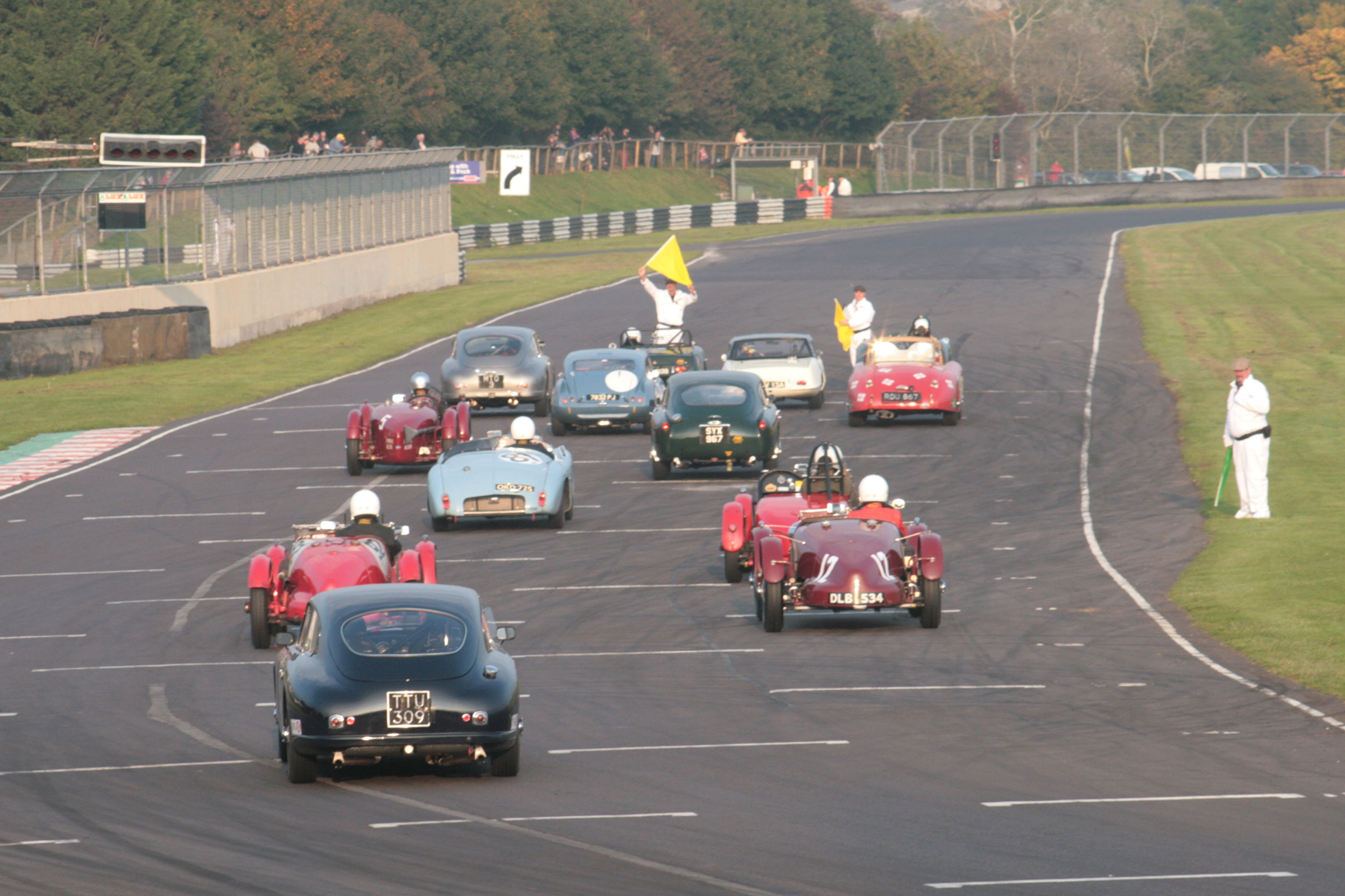 The cars form up on the grid, with Nick Ruddell, given no qualifying time taking his place at the back of the field in his Aston Martin DB2/4 Photo - John Turner 