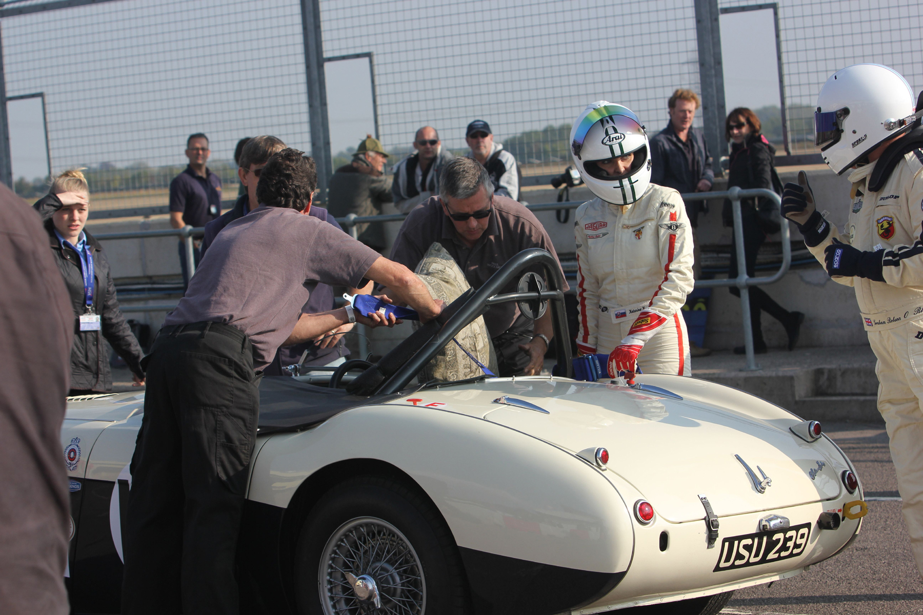 Katarina Kyvlova listens to some sage words from car owner Graham Robson before she replaces him in the hot seat of the Austin Healey 100M. The 'Cool Dude' in shades is Paul Woolmer of Woolmer Classic Engineering, our sponsor and provider of excellent hospitality unit throughout the season. Photo - Pat Arculus, Tripos Media