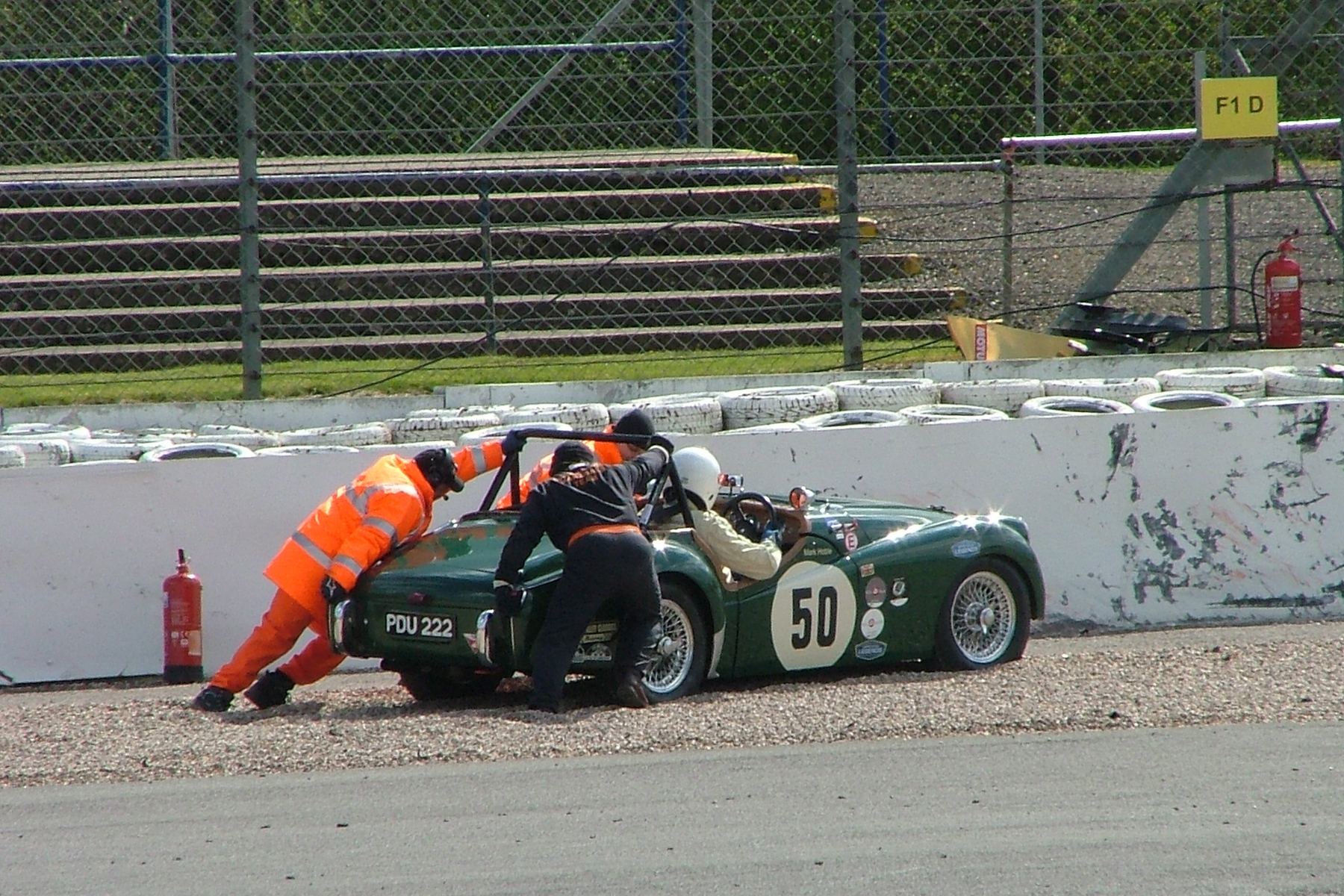 It was great to see Mark Hoble out with us in his Triumph TR2 after an absence of some years, but his practice was not without drama as a clutch problem forced him to pull off at the marshals post just beyond Copse. Mark resolved the problem and was able to start and finish the race. Photo - John Turner