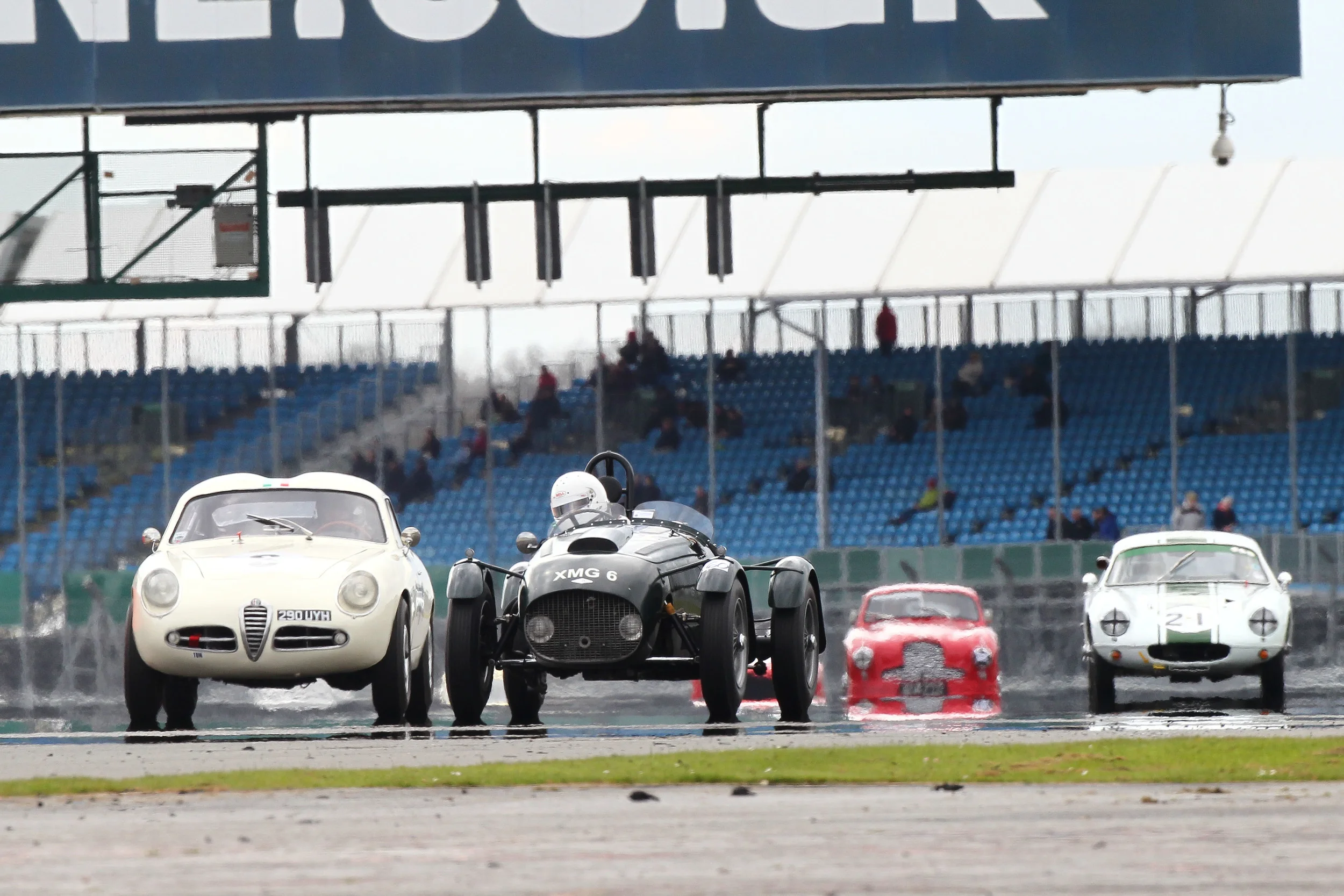 Brian Arculus (Alfa Romeo) and Martyn Corfield (FNLMR) fought an incredibly close duel. In the background Barry Dye's Lotus Elite and Paul Chase- Gardners Aston Martin DB2 Photo - Richard Styles