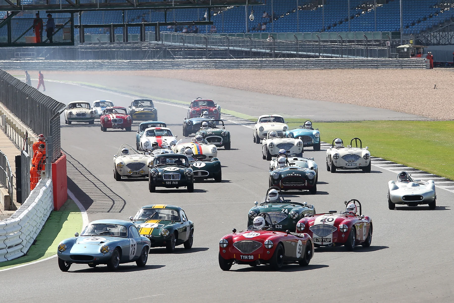 The Lotus Elites of Robin Ellis and Mike Freeman take advantage of the inside line to make places . All the cars but one are in picture here with the exception being Terry Bryant's MGA hugging the pitwall. Photo - Mick Walker