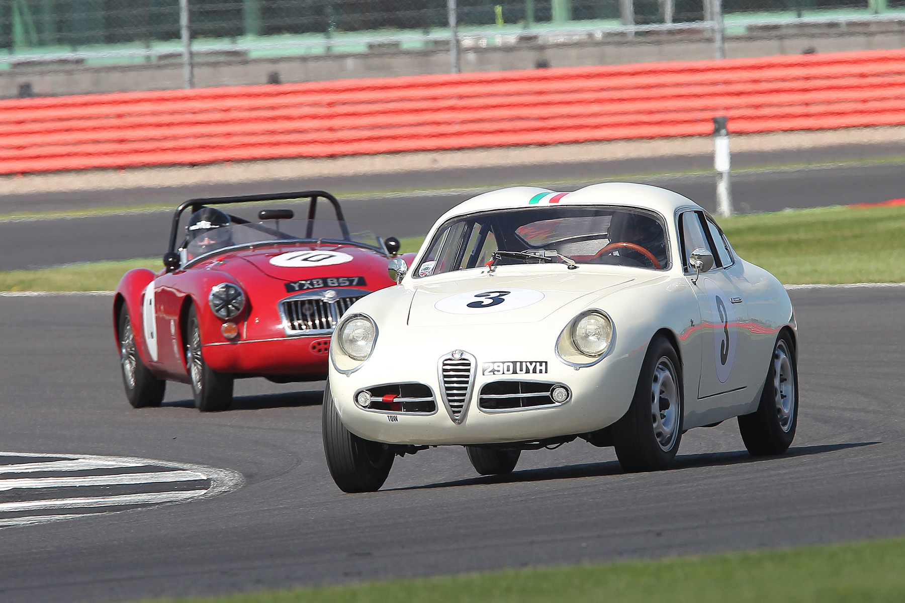 Brian Arculus presses on regardless in the misfiring Alfa Romeo. Photo - Mick Walker
