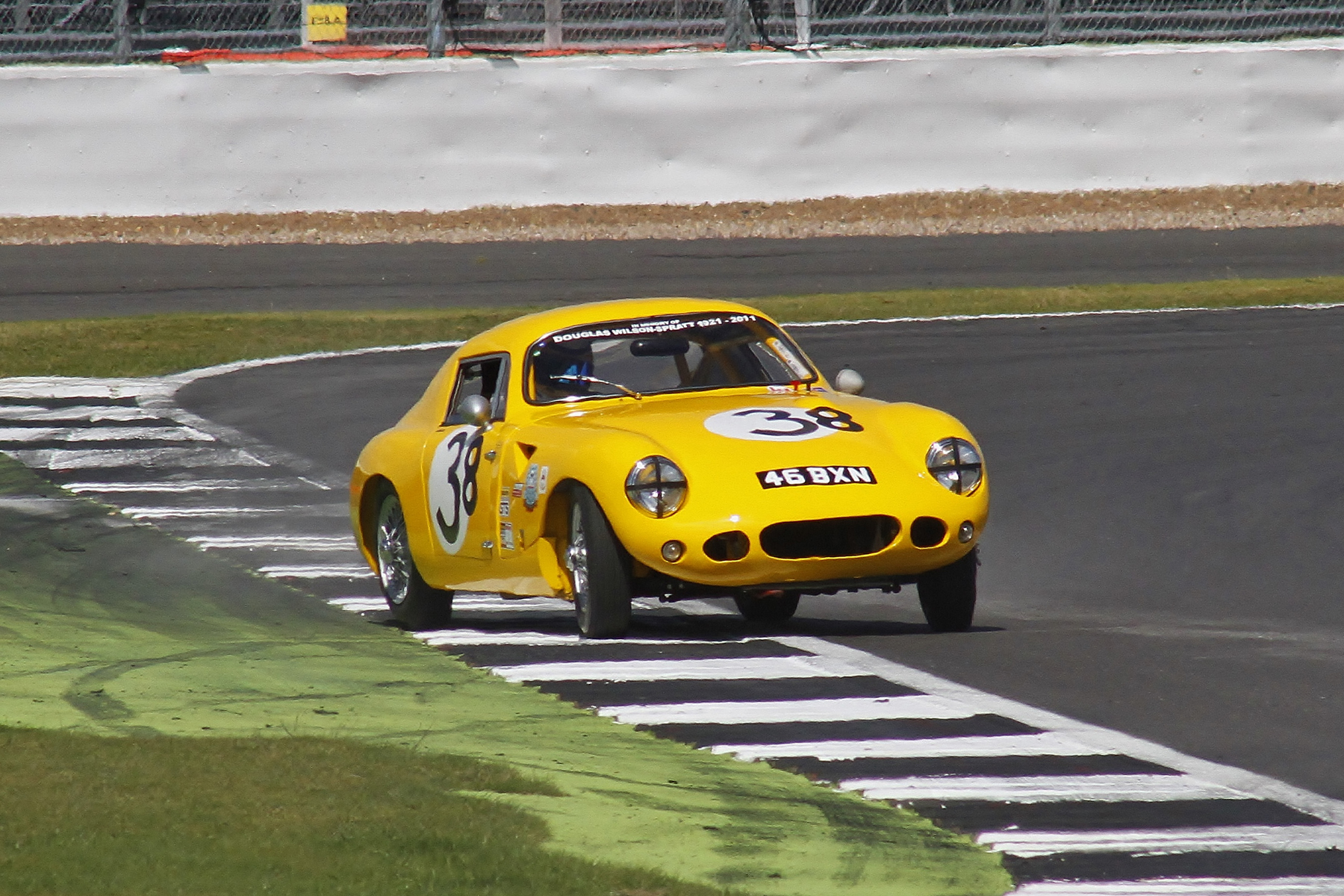 The gorgeous Sebring Sprite of Richard Woolmer gets a tad offline. Note the tribute to the late Douglas Wilson-Spratt whose son was in the race driving a car built by Douglas Photo - Bob Bull, Tripos Media