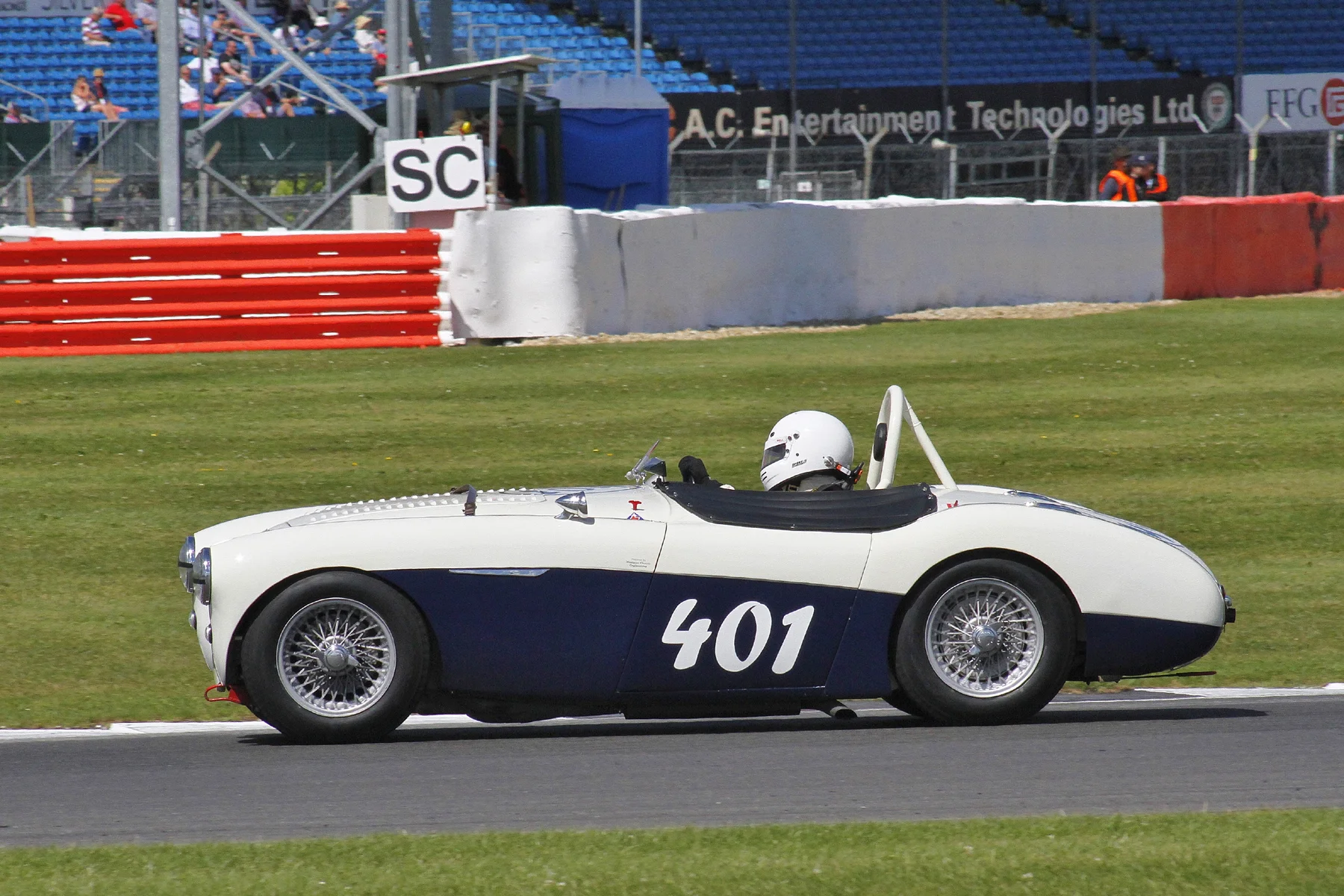Jason Harris on his way to 8th in the Austin Healey 100/4 . The colour coded roll hoop will be much appreciated by aesthetes Photo - Bob Bull, Tripos Media