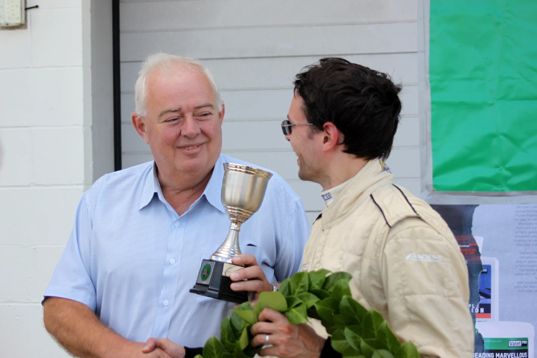 Bic Healey's son, Peter (left) presents Jonathan Abecassis with the Bic Healey Trophy. There is a real historic symmetry to the fact that the grandson of Donald Healey presents the trophy to the grandson of George Abecassis. Photo - Bob Bull, Tripos Media