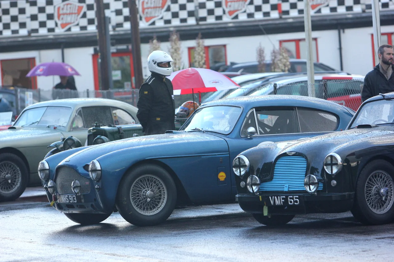 A few of the Astons lined up in the paddock. Far left is Mark Campbell's ex privateer Le Mans DB2, almost hidden from view is the splendid Ecurie Bertelli entered Ulster for Simon Diffey, Simon Jeffries DB MkIII and Justin Kennedy's famous ex works DB2, VMF65, driven by Tony Green. Photo - Pat Arculus, Tripos Media